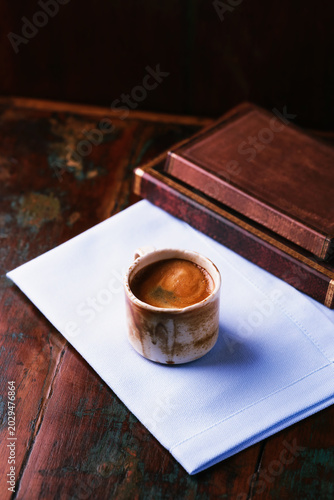 Cup of coffee on rustic wooden background. Soft focus. Copy space