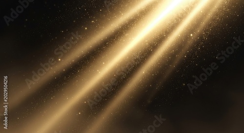 Golden light rays and dust particles on dark background.