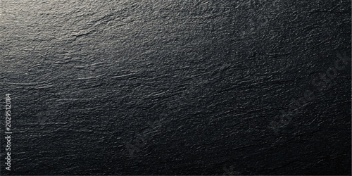 Fotografie close-up of textured dark grey stone surface with natural uneven pattern, offering a sense of raw, earthy elegance