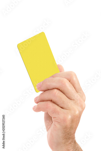 Hand showing yellow card