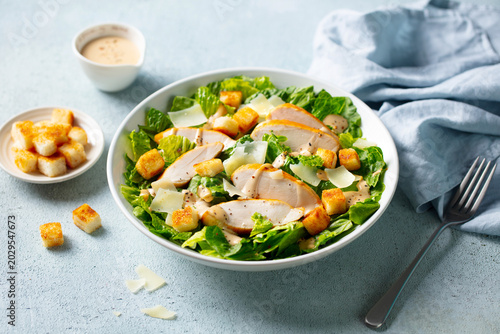 Healthy Caesar Salad with croutons, creamy dressing, fresh romaine lettuce, shaved parmesan. Close up