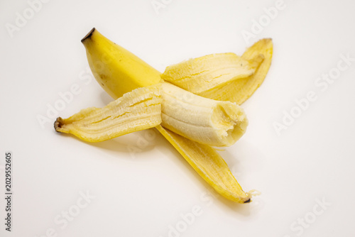 peeled banana on white background