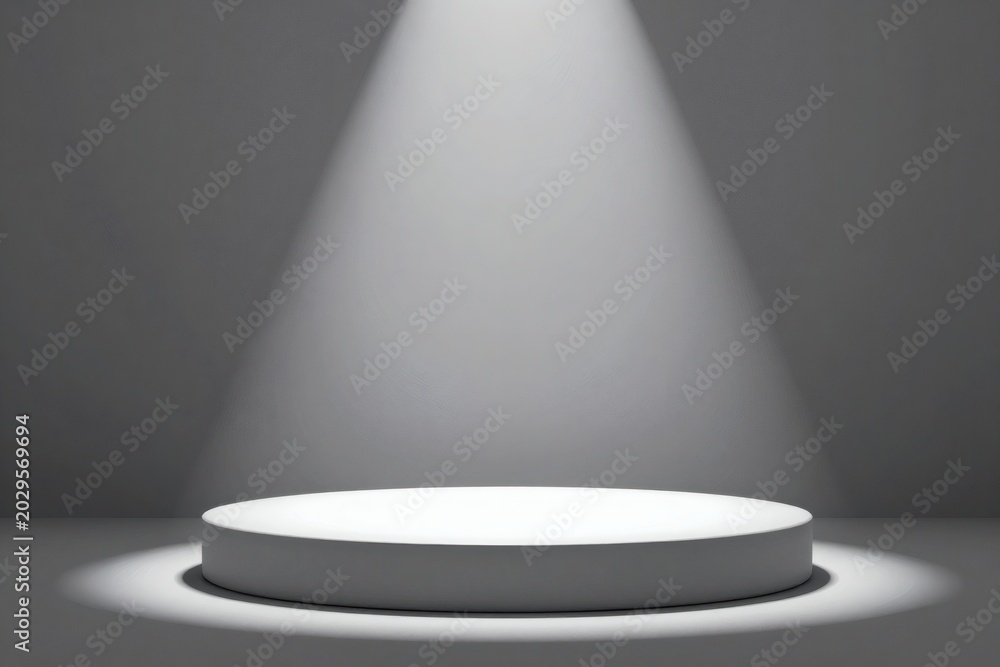 Obraz premium Elegant spotlight shining on a round white platform in a gray studio