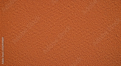 Texture of red clay tennis court surface close up