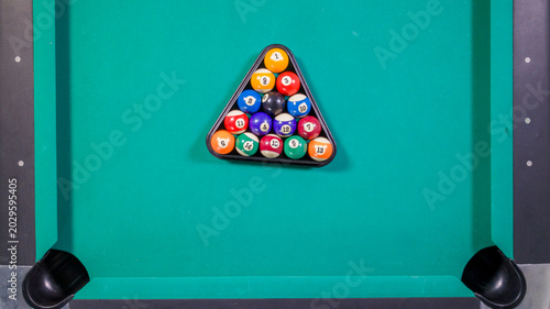 Top View of Billiard Balls Racked in a Triangle on Green Felt Table