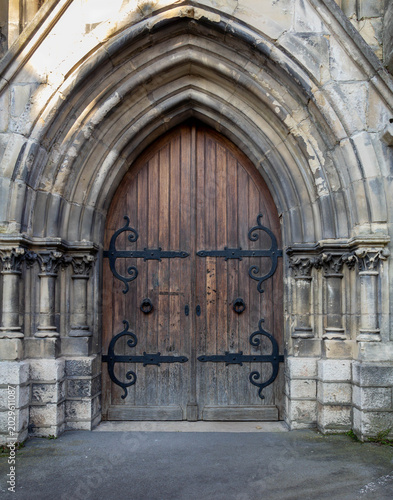Old Wooden Church Door with Gothic Stone Arch