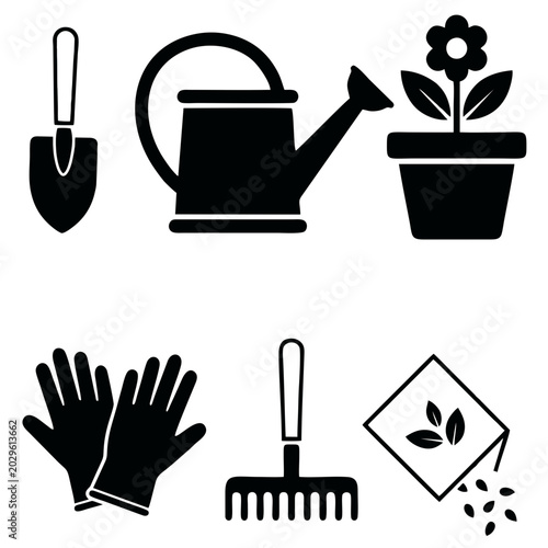 Gardening tools and flower pot with gloves and seeds on ground