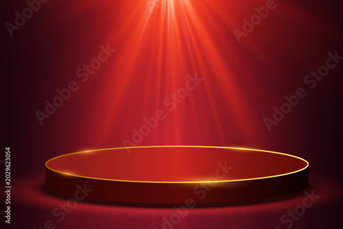 Red circular podium platform with golden border and dramatic spotlights creating a luxurious stage