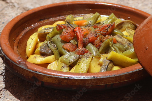 A close-up shot of a moroccan tajine with vegetables, traditional food