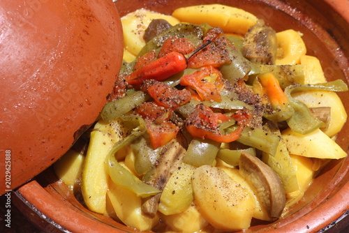 A close-up shot of a moroccan tajine with vegetables, traditional food