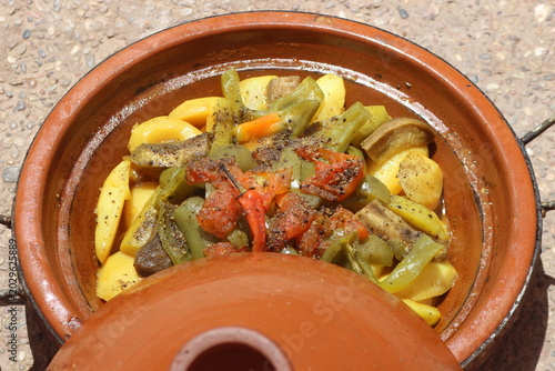 A close-up shot of a moroccan tajine with vegetables, traditional food