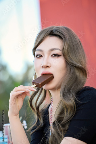 Obraz na płótnie Asian beauties dressed in Korean style and holding ice cream outdoors
