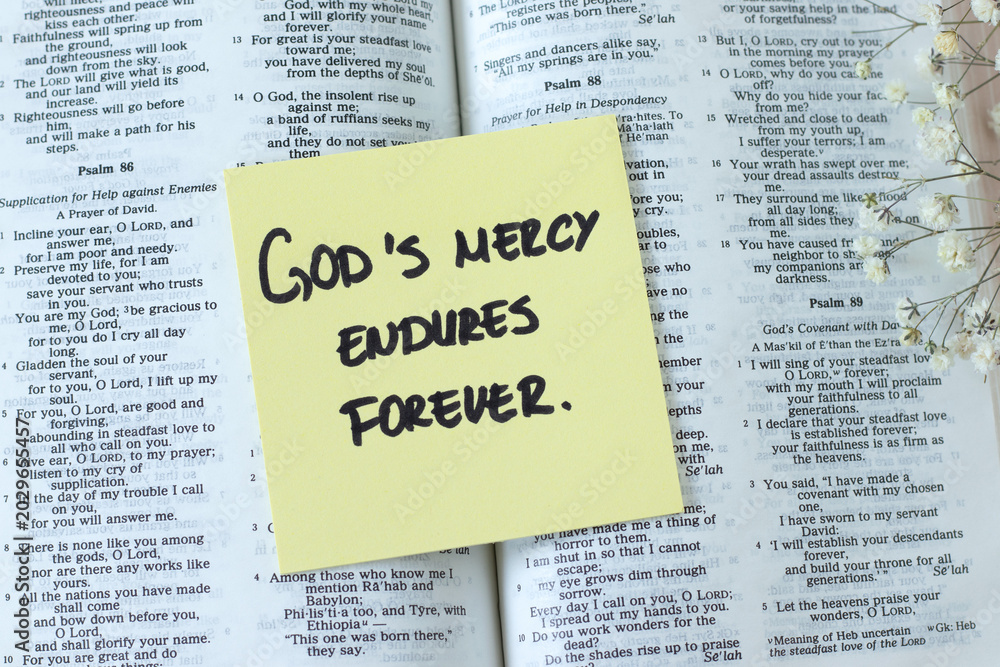 Obraz premium God's mercy endures forever, inspirational quote with open holy bible book. Jesus Christ's grace, compassion, and forgiveness, biblical concept.
