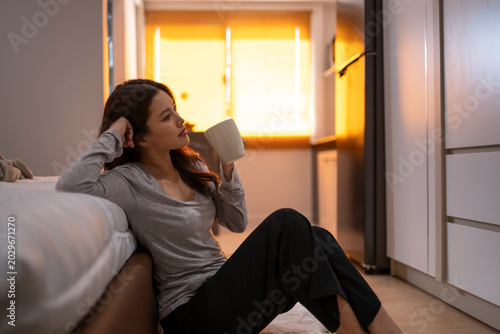Canvastavla Woman relaxing with hot drink in golden hour morning