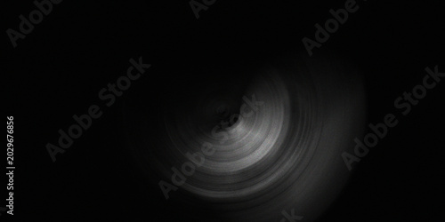 Bild auf Leinwand Dark circular motion blur vortex background with subtle metallic grey ring pattern and mysterious central deep hole light effect