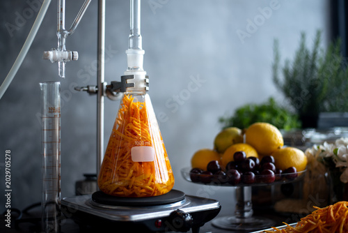 Fotografie Glass distillation apparatus extracting essential oil from flowers in a laboratory