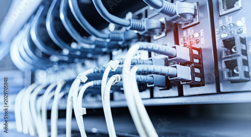 Obraz na płótnie High-Speed Fiber Optic Cables Connected to Network Ports in Data Center Server Rack, IT Infrastructure and Cloud Computing Concept