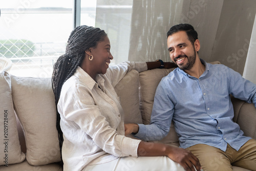 Tableau sur toile Diverse couple smiling, having meaningful mental health conversation