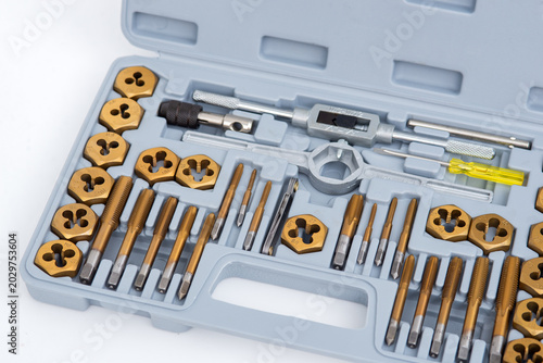 Professional tap and die set with titanium-coated thread cutting tools organized in a gray plastic case.