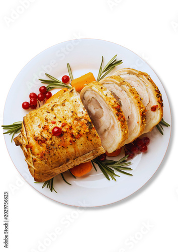 Slices of roasted pork roll or porchetta served on a white plate, garnished with fresh rosemary sprigs, carrots, and red cranberries, isolated on a white background. Perfect for festive holiday dinner