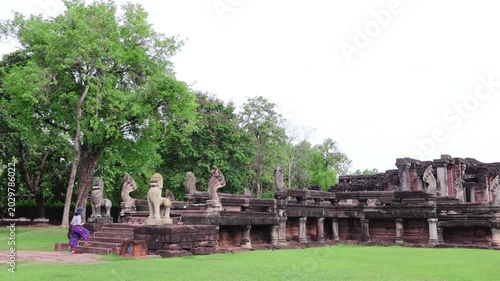 Female traveler walking up ancient Naga bridge at Phimai Historical Park, Nakhon Ratchasima, Thailand