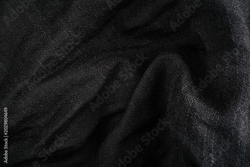 Black sheer fabric folds with subtle shine