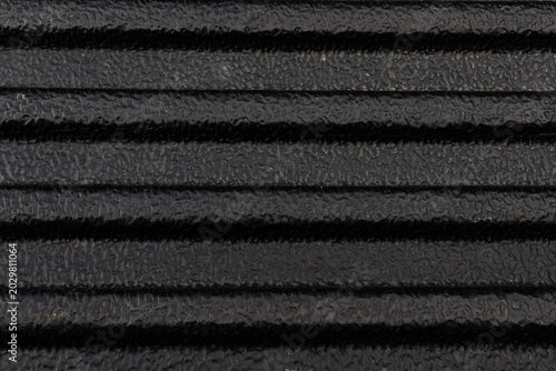 Cuadro en lienzo Close-up texture of a black ribbed rubber mat or tough plastic truck bed liner with a rough, non-slip surface