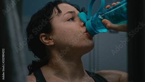 Bild auf Leinwand Close Up of Breathless and Covered in Sweat, Young Sporty Woman in Locker Room Recovering After Difficult Training Session