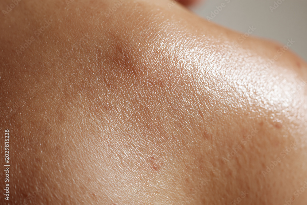 Fototapeta premium Close up macro photography of healthy skin texture with natural sheen and fine pores, detailed skin surface showing subtle hair and moisture glow