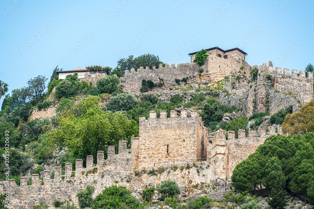 Fototapeta premium The scenic views of the Alanya Castle, surrounded by walls of 6 km length and situated on 10 hectares of the peninsula, hosted Hellenistic, Roman, Byzantine, Seljuk, Ottoman civilizations in Alanya
