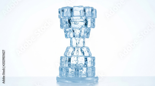 A stunning sculpture made of transparent ice cubes, resembling a modern trophy, set against a bright, minimalistic background.