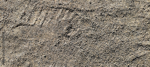 Foto Texture of rough gravel and coarse sand on the ground