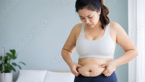 Asian Woman Pinching Belly Fat, Weight Gain and Body Care Awareness Wellness Photography