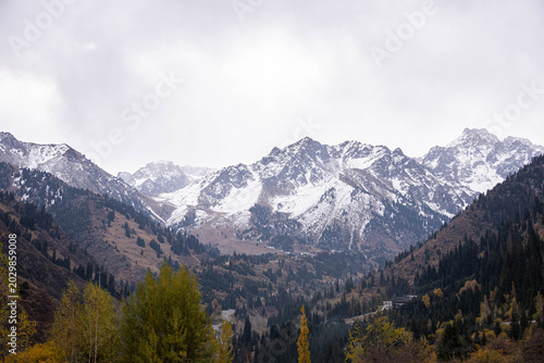 Fotografie Majestic snow-capped mountains rise dramatically in the Medeo region of Kazakhst