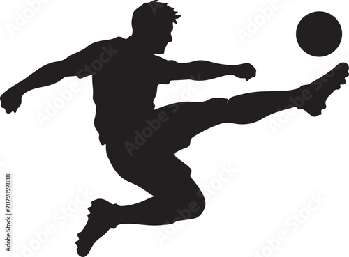 Bild auf Leinwand silhouette of a football player kicking the ball in mid-air