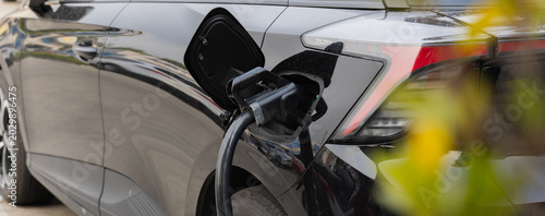 Electric car charging station. Hybrid car Electric charger station in the Car Park. Electric car charging on parking and charging station. Electric socket. Transportation EV