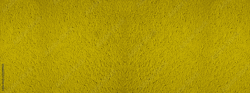 Fototapeta premium Background of natural yellow gold golden stucco in plaster cement texture lined pattern or stone in colors aged Textured illuminated wall fence surface blend of warm sunny tones backdrop.