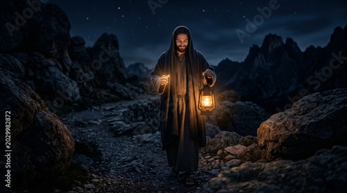 Man dressed as Jesus walking on path at night holding lantern. Religious figure exploring rocky terrain under starry sky. Spiritual journey and divine light concept in dark landscape.