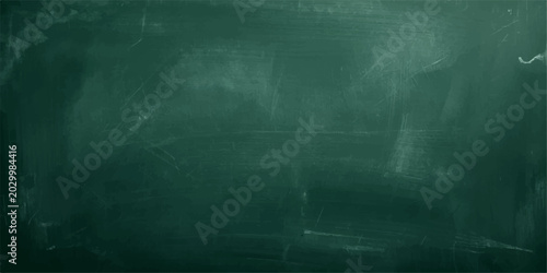Bild auf Leinwand An empty, aged blackboard with chalk on a dark, textured grunge wall backdrop
