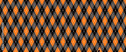 ​Seamless Halloween argyle pattern with orange, black, and grey diamond shapes and stitched details. Festive autumn geometric background vector.