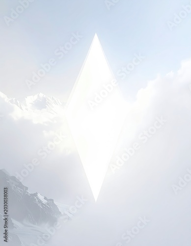 Ethereal diamond of light hovers over misty, snow-capped mountains