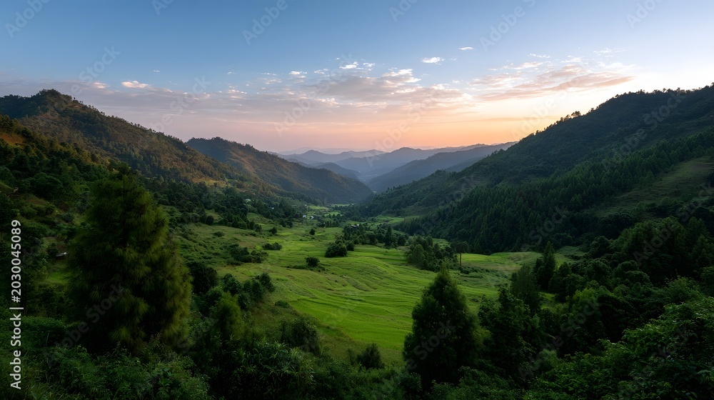 Fototapeta premium An expansive landscape of rolling green hills and valleys viewed under a dramatic morning or evening sky