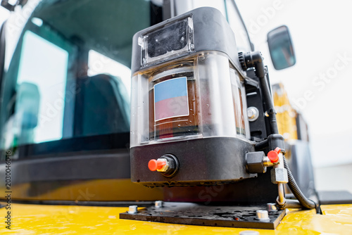 Obraz na plátně Close up of an automatic chassis lubrication system grease pump reservoir with f