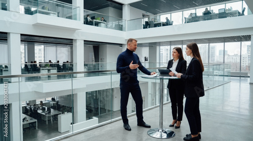 Business meeting in modern open-plan office: Manager presenting ideas to team, overlooking city skyline