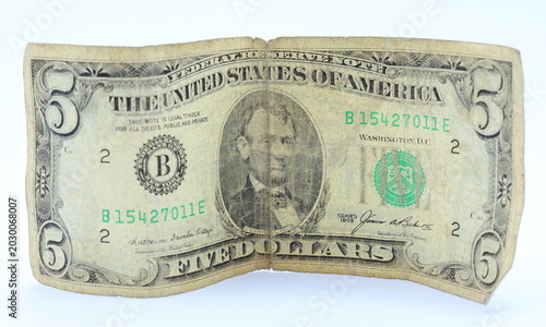 Foto Old torn faded five dollar bills banknotes