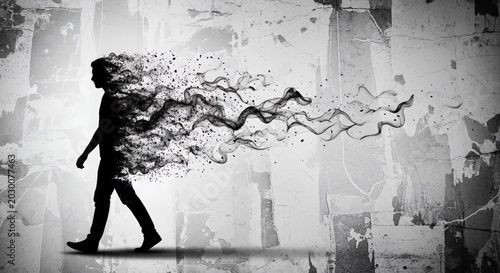 Silhouette of walking person dissolving into smoke particles.