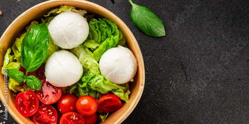 Mini buratta salad buratta cheese tomato, green leaf lettuce, mozzarella lunch or dinner tasty organic snack fresh delicious gourmet food background on the table rustic food top view copy space 