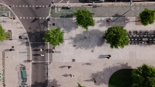 top down aerial view of an urban street in Lisbon, Portugal featuring parked cars, pedestrian walkways, bicycle lane markings, trees, and geometric city patterns near Jardim Dom Luis.