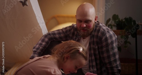 Daughter Putting Makeup on Her Bald Bearded Father While Playing in a Cozy Blanket Fort