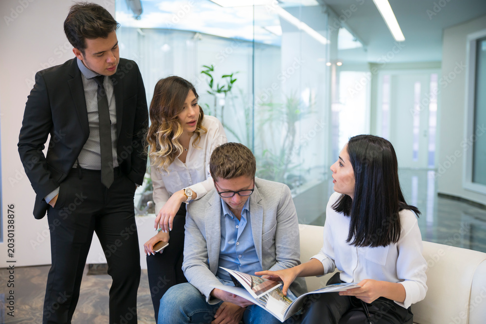 Fototapeta premium Business professionals collaborating on documents in a modern office
